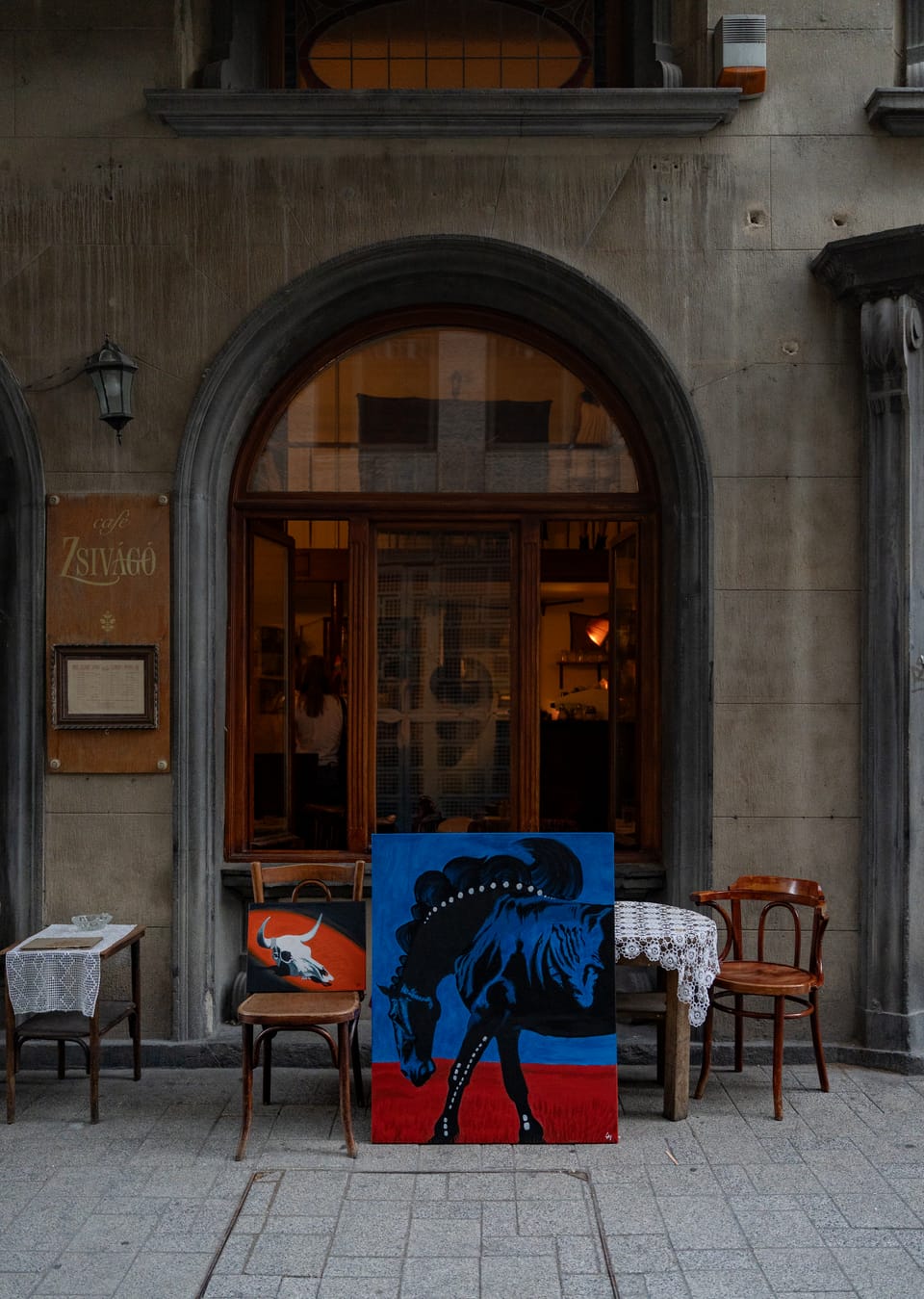 Two paintings resting outside Café Zsivágó