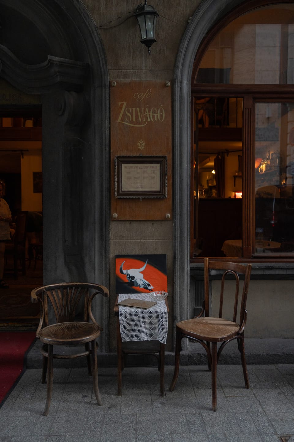 No Country resting on a bentwood chair outside the café